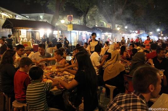 People eating street food in Singapore at the Lau Pa Sat market