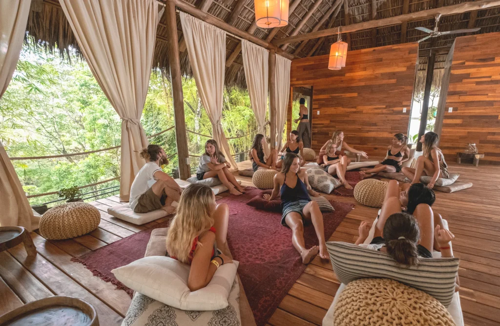 group of women sitting around in a hostel communal space and chatting