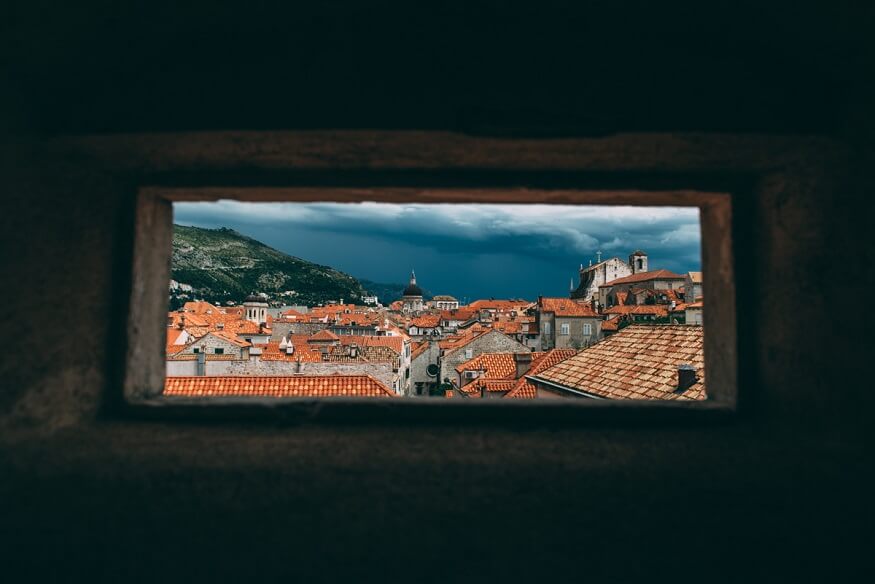 View of Dubrovnik rooftops through a narrow window (c) Lola Wright