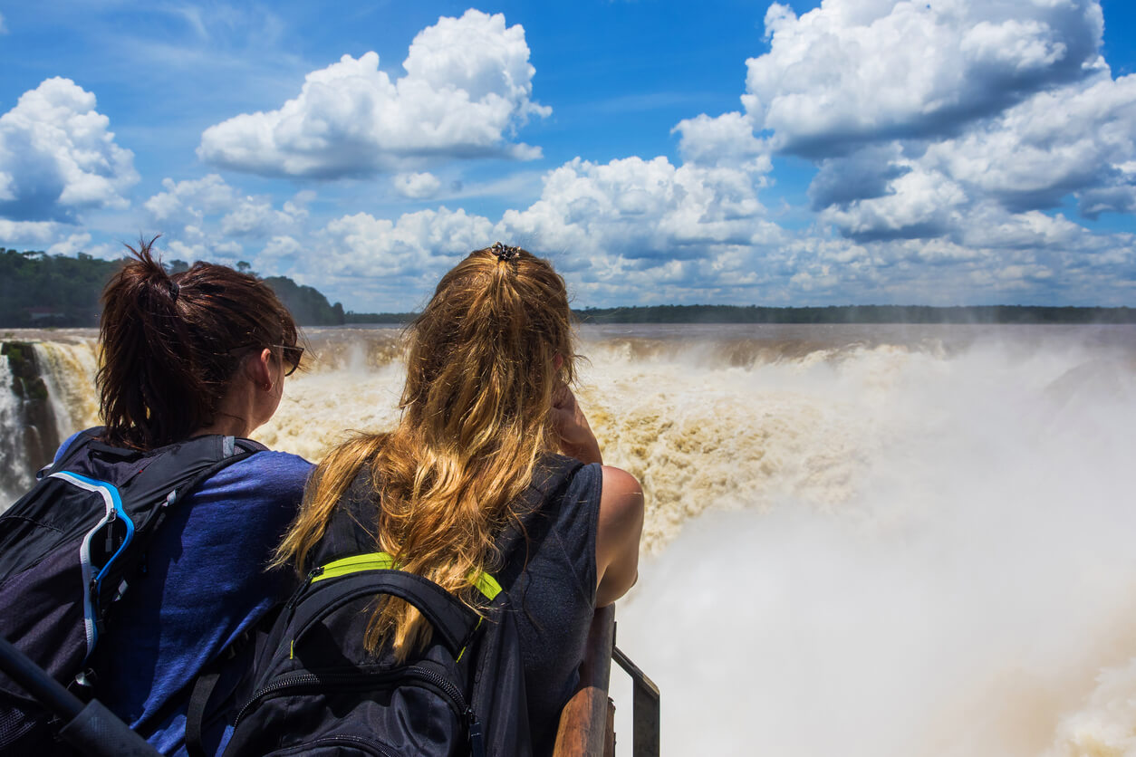 Puerto Iguazu, Argentina - December 8, 2015: Caucasian tourists looking at view at Devil's Throat (Garganta del Diablo), the largest cascade at Iguazu Falls in Puerto Iguazu, Argentina.