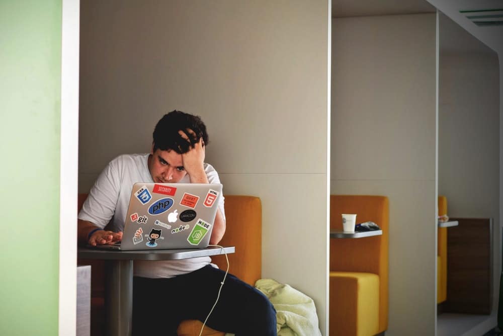 travel anxiety - tense man and laptop