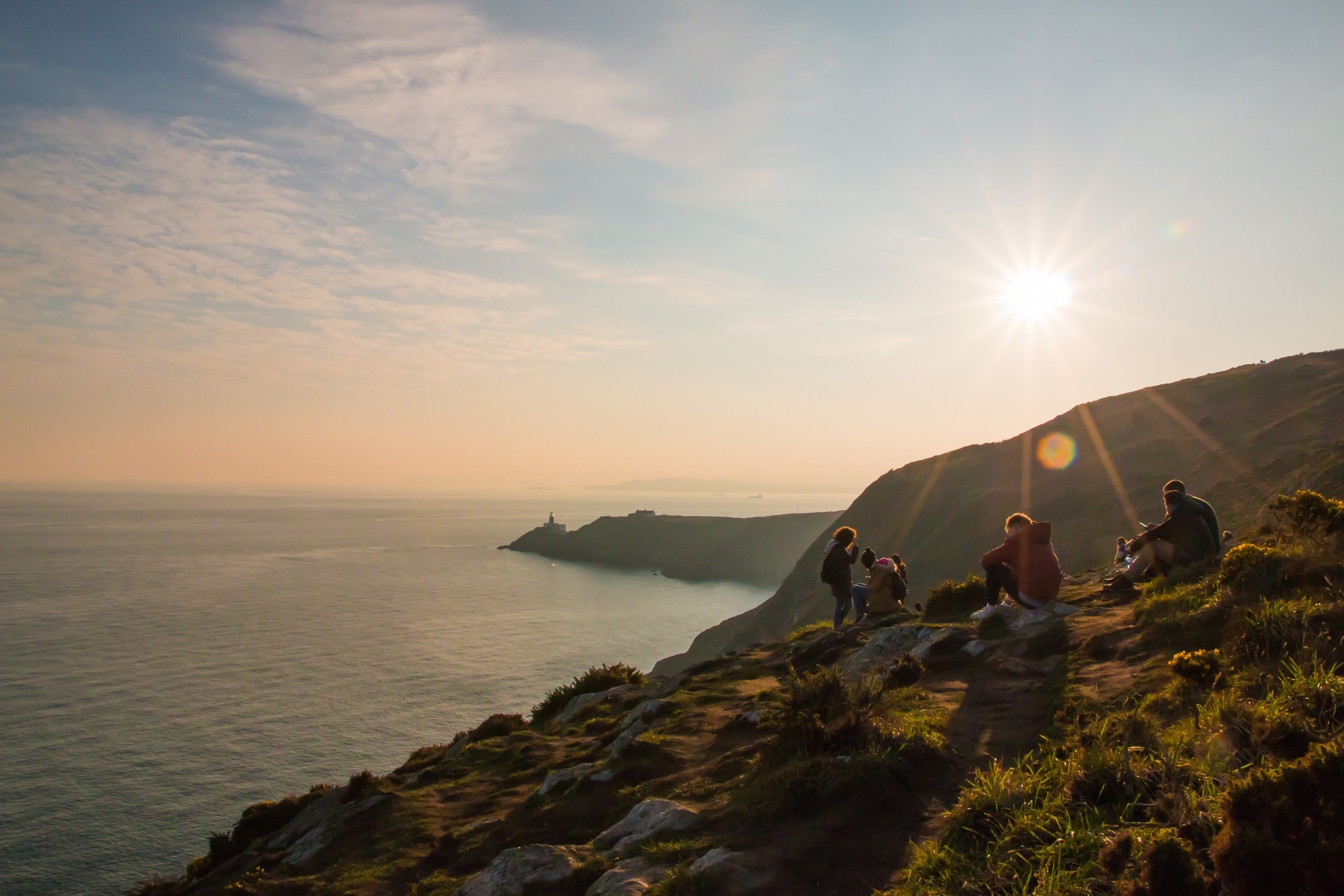 Save money on group trips - friends watching sunset