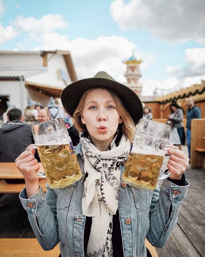 best beer in europe - woman holding two beer tankards