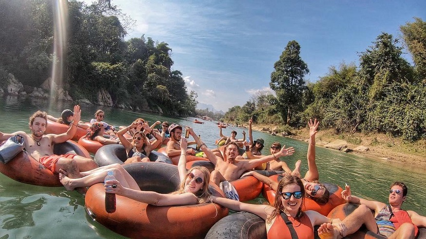 backpacking Laos - group of people tubing down river