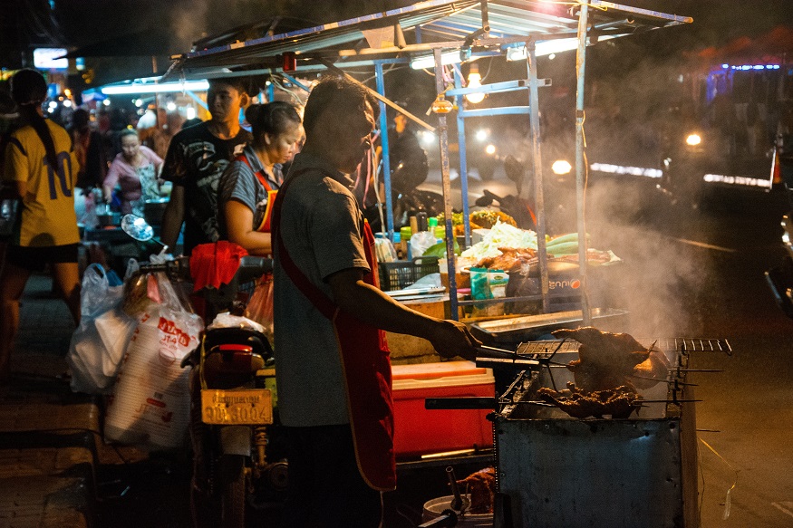 backpacking Laos - man cooking street food