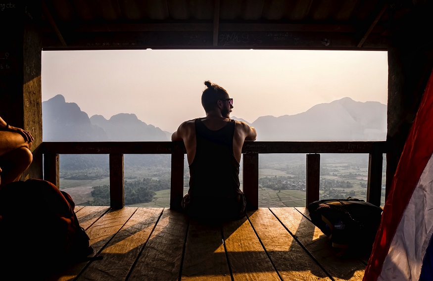 backpacking Laos - man looking out onto valley