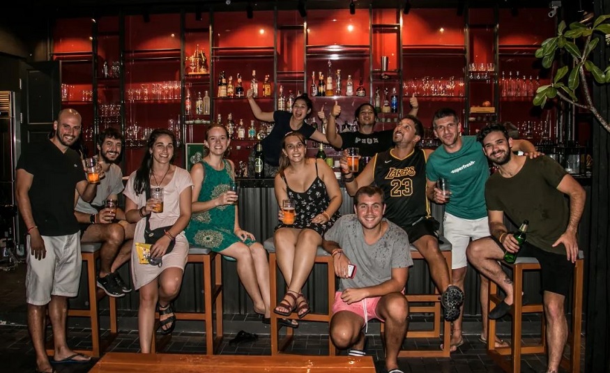 where to stay in Bangkok - Luk Hostel - group of people drinking 
