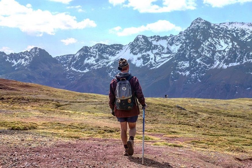 backpacking chile, man with rucksack and shorts hiking in the mountains