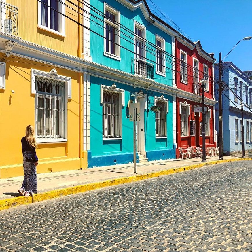 backpacking chile, girl walking down street with mutli coloured buildings
