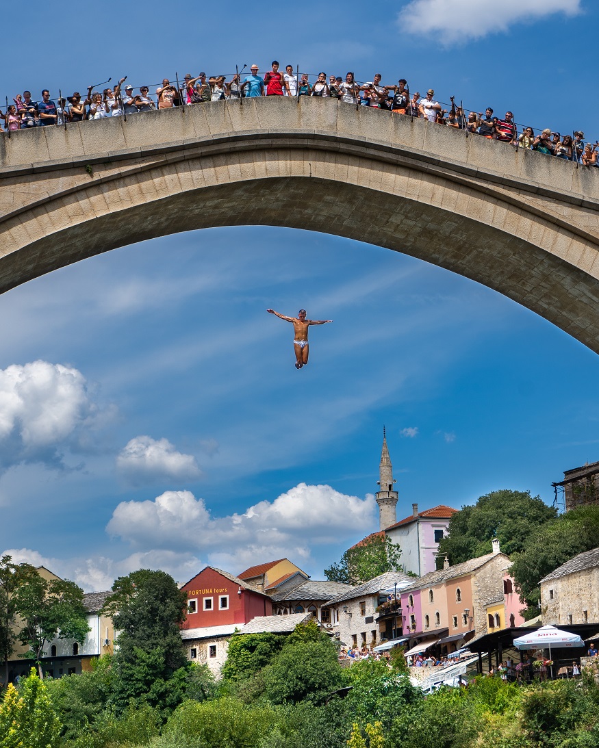 best places to visit in eastern europe, man jumping off Stari Most bridge in Mostar