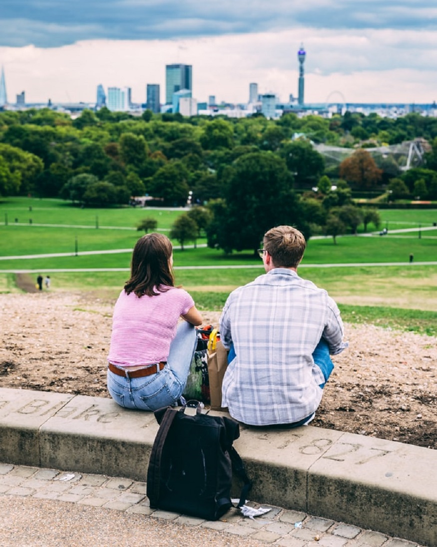 places to go for new years eve uk, two people sitting on primrose hill