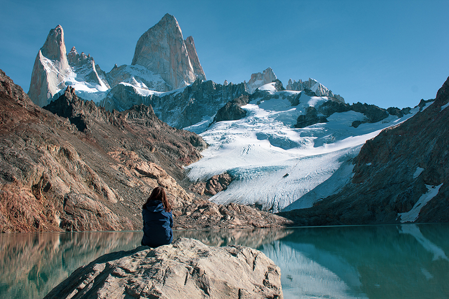 best places to visit in Argentina, girl sitting by a lake in the mountains in patagonia