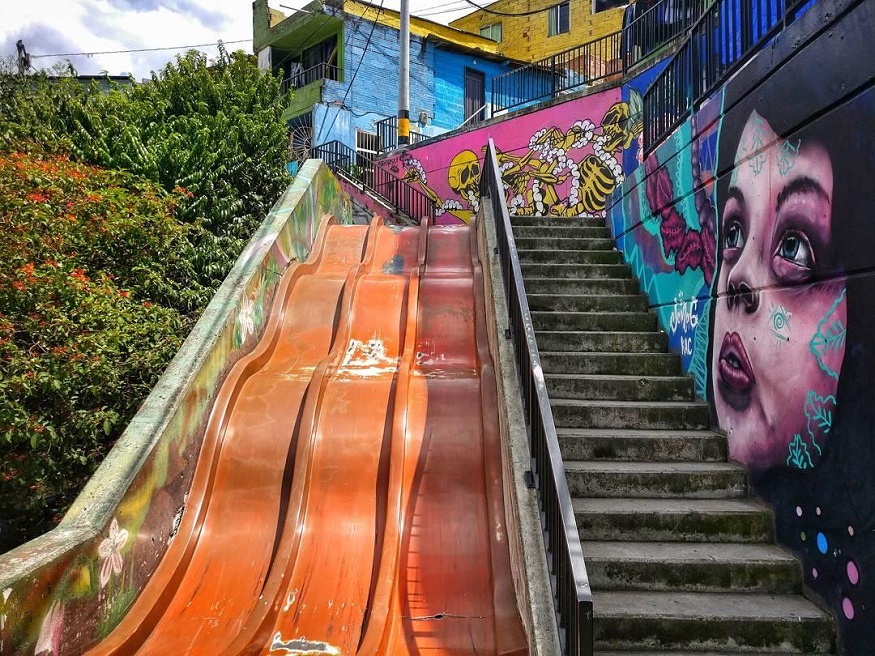 best places to visit in colombia, a slide next to steps and street art in medellin