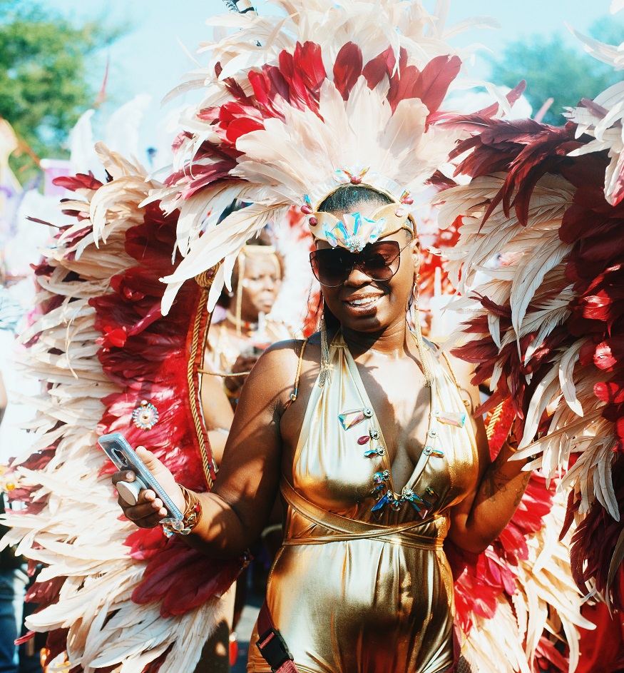 best places to visit in colombia, woman in a red and white feather headdress