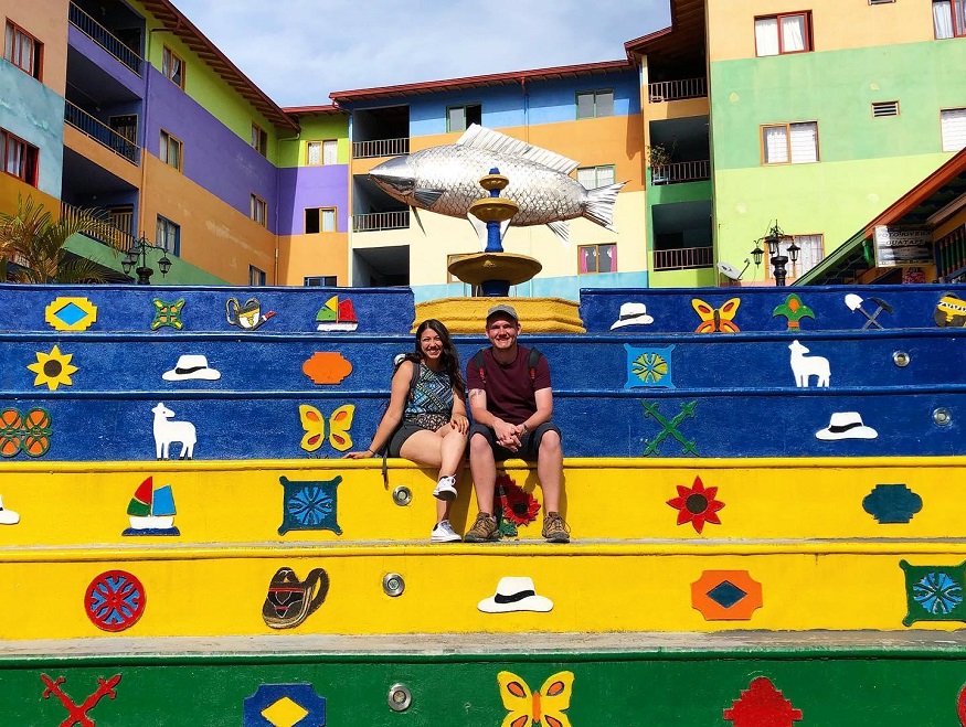 best places to visit in colombia, two people sitting on coloured steps in guatapé