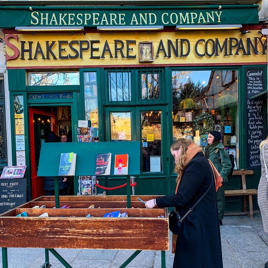 best destinations for book lovers, girl looking at books by shakespeare and company bookshop
