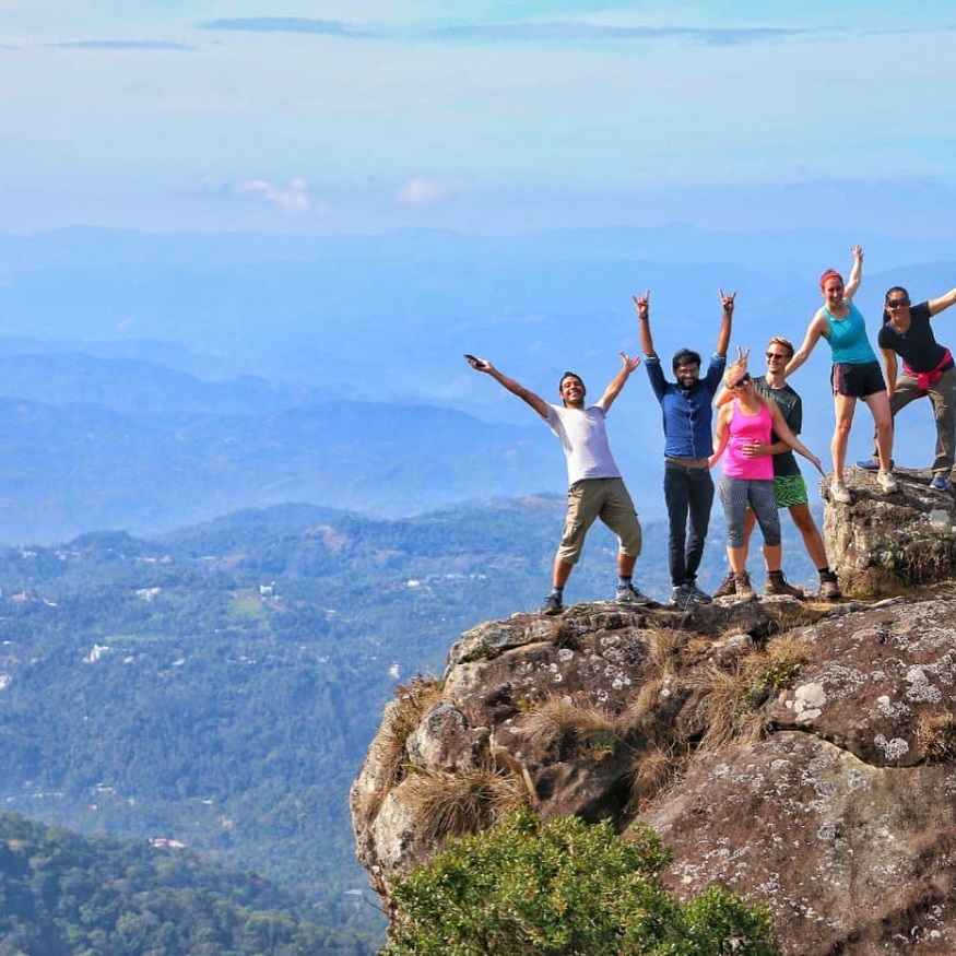 best destinations for book lovers, group of people on rock at Munnar