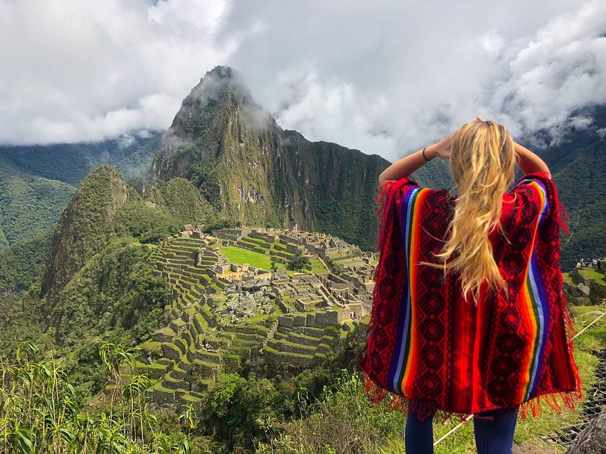 best train journeys, girl standing at top of Machu Picchu