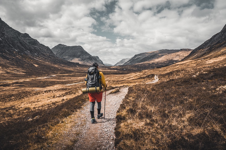 best train journeys, person hiking through mountains in Fort William