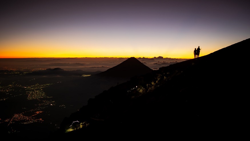 best places to visit in Guatemala, two people hiking Volcan Acatenango in Guatemala at sunrise
