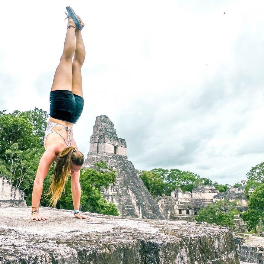 best places to visit in Guatemala, girl doing handstand in Tikal on ruins