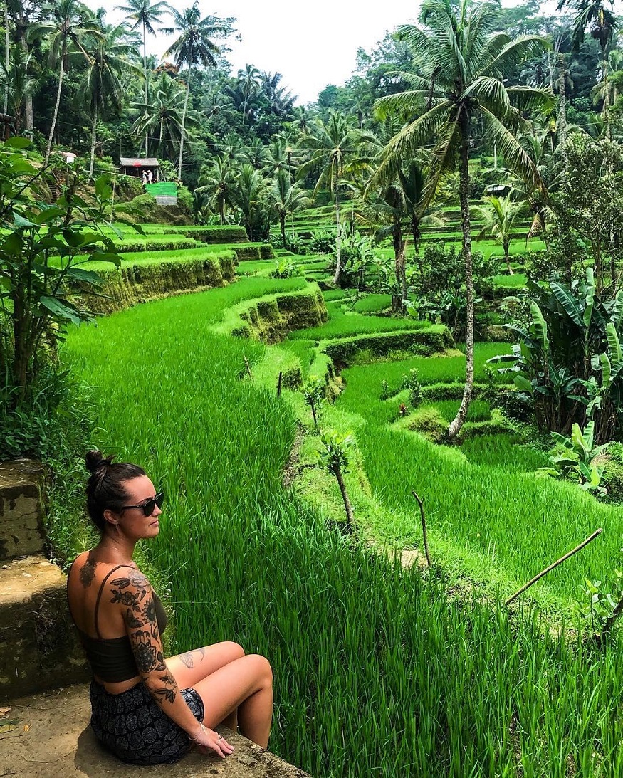 best romantic destinations for solo travellers, girl sitting by fields in bali