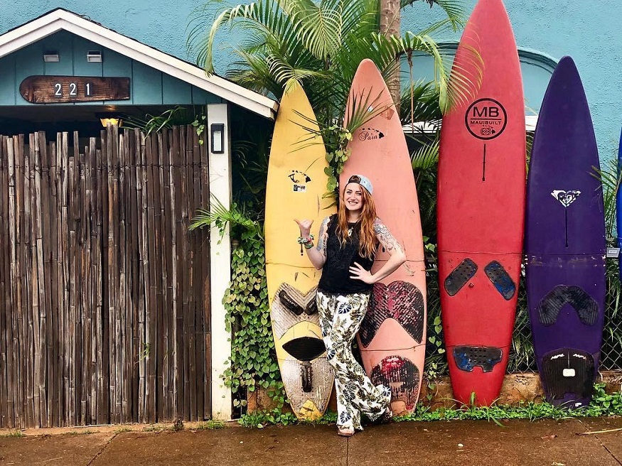 best romantic destinations for solo travellers, girl standing by surfboards in miami