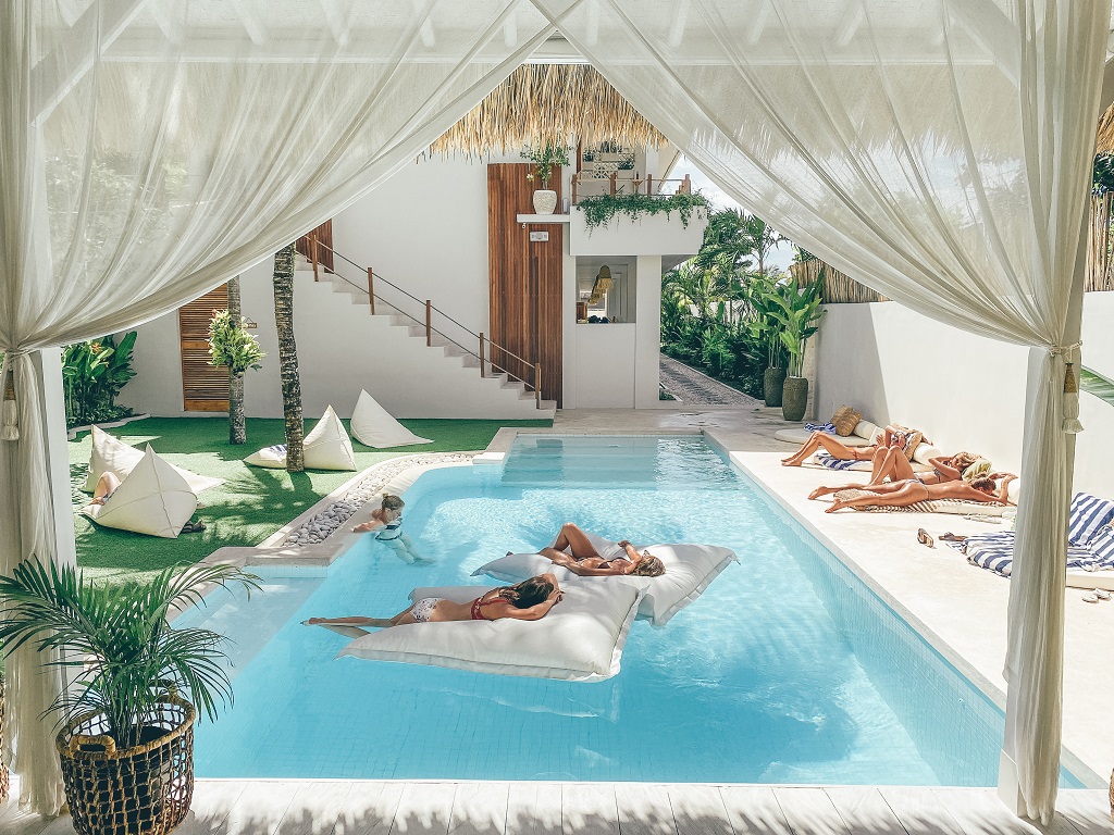wish-listed hostels - people floating in the pool at Arya Wellness Retreat hostel in Bali