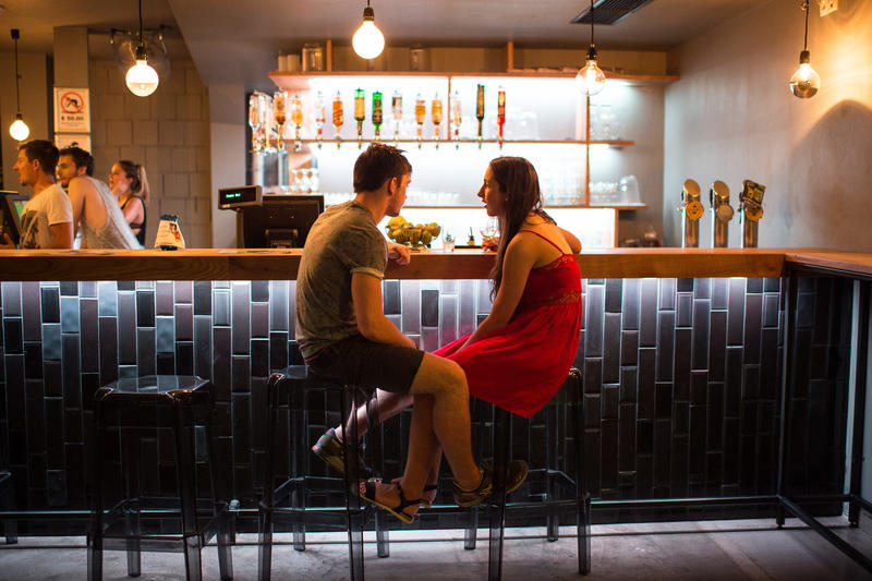 wish-listed hostels - two people sitting at the bar at Wombat’s City Hostel Vienna