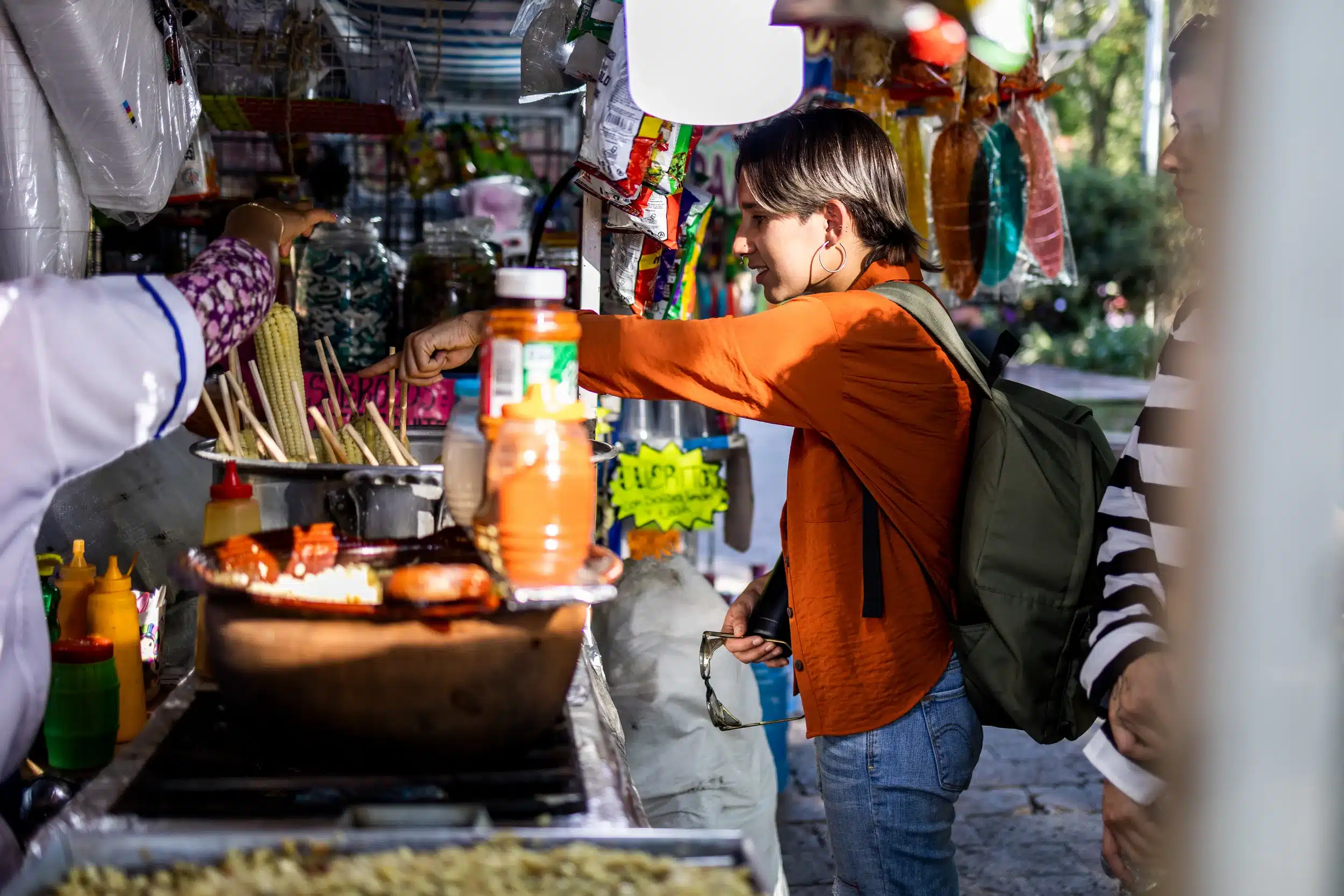 Young tourist buying food at the local food stand
