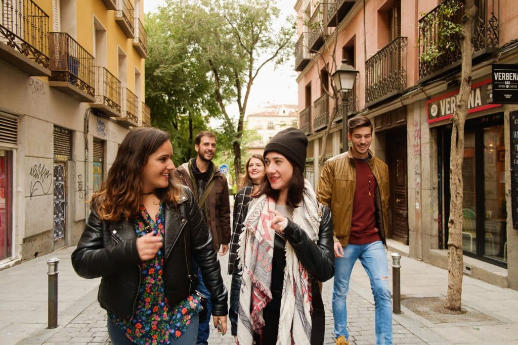 group walking in a street in Madrid, having a conversation and exploring the city