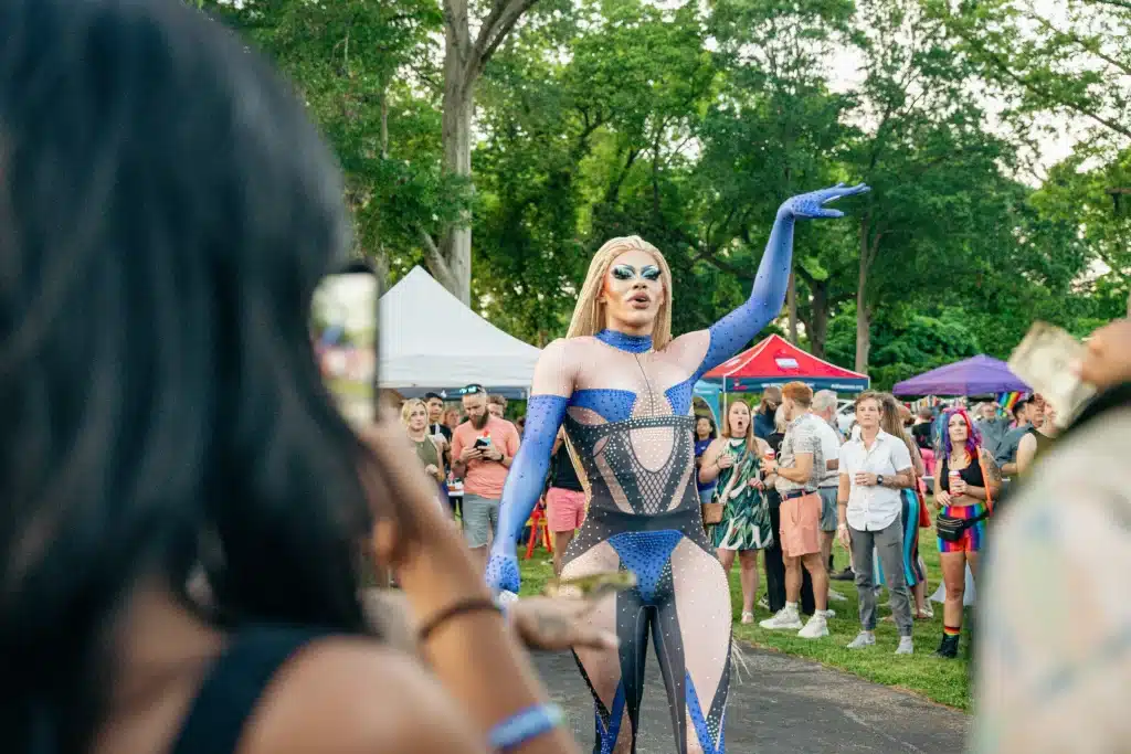 drag queen performing outside with people watching