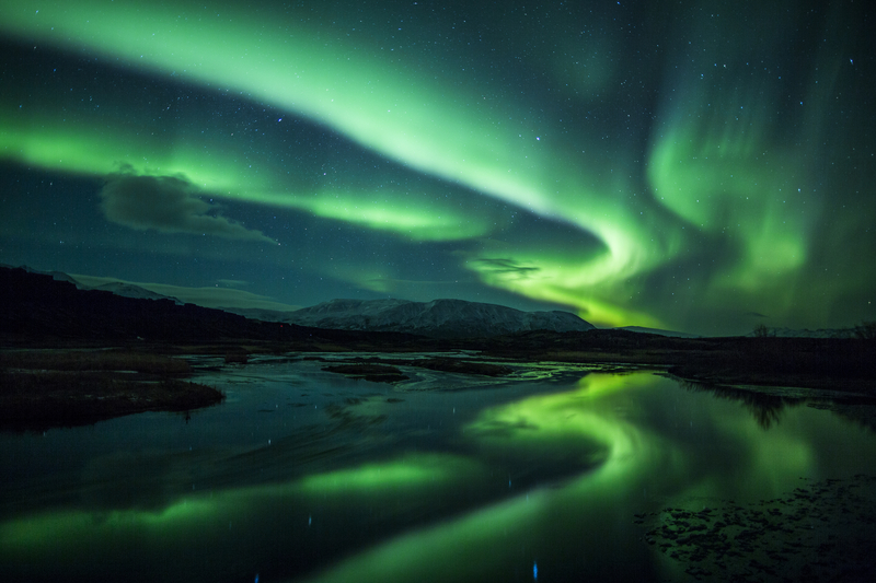 Northern Lights Above a Lagoon in Iceland - Solo Adventure Travel