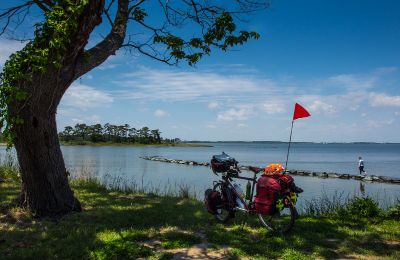 View of Bike at a Beautiful Setting near Water - Bike Tour Solo Travel