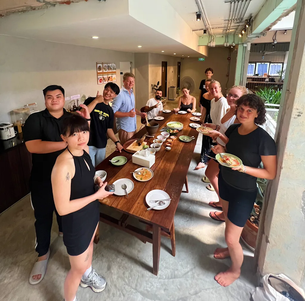 people gathered for a meal, standing up for a photo