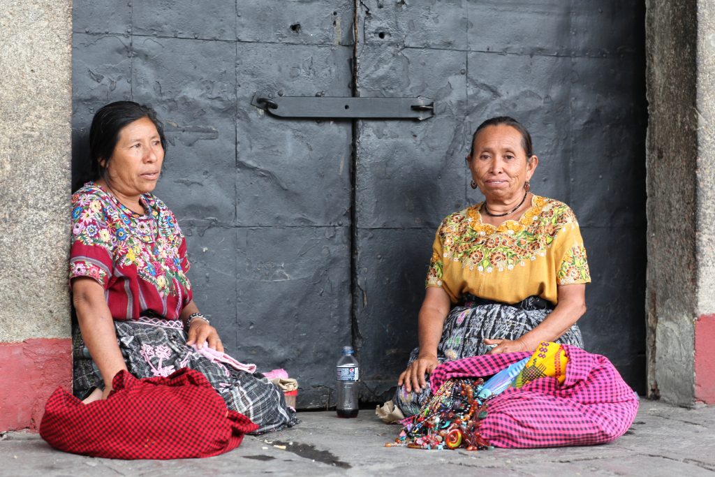 Maya women in Guatemala antigua, in the streets in front of a church