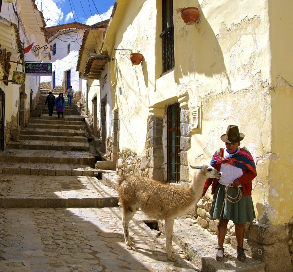 Native Woman from Peru with Lama. Native quechua woman with lama in colonial street of picturesque neighborhood of San Blas, Cusco, Peru