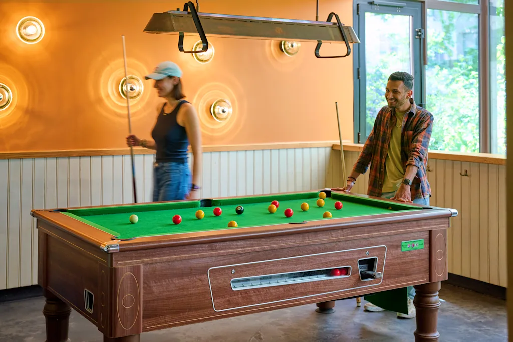 two people playing billiard