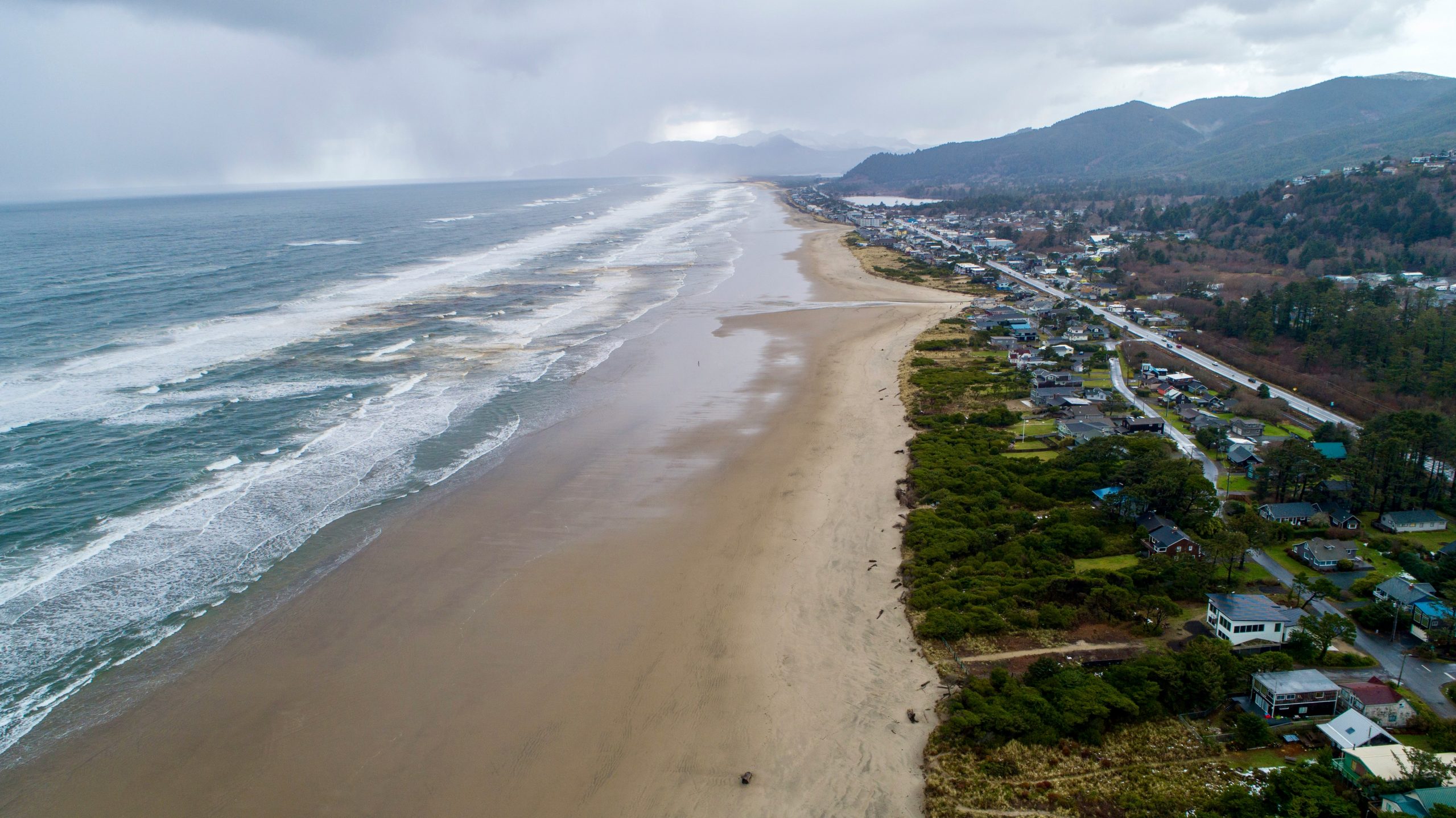 an aerial view of a beach and town