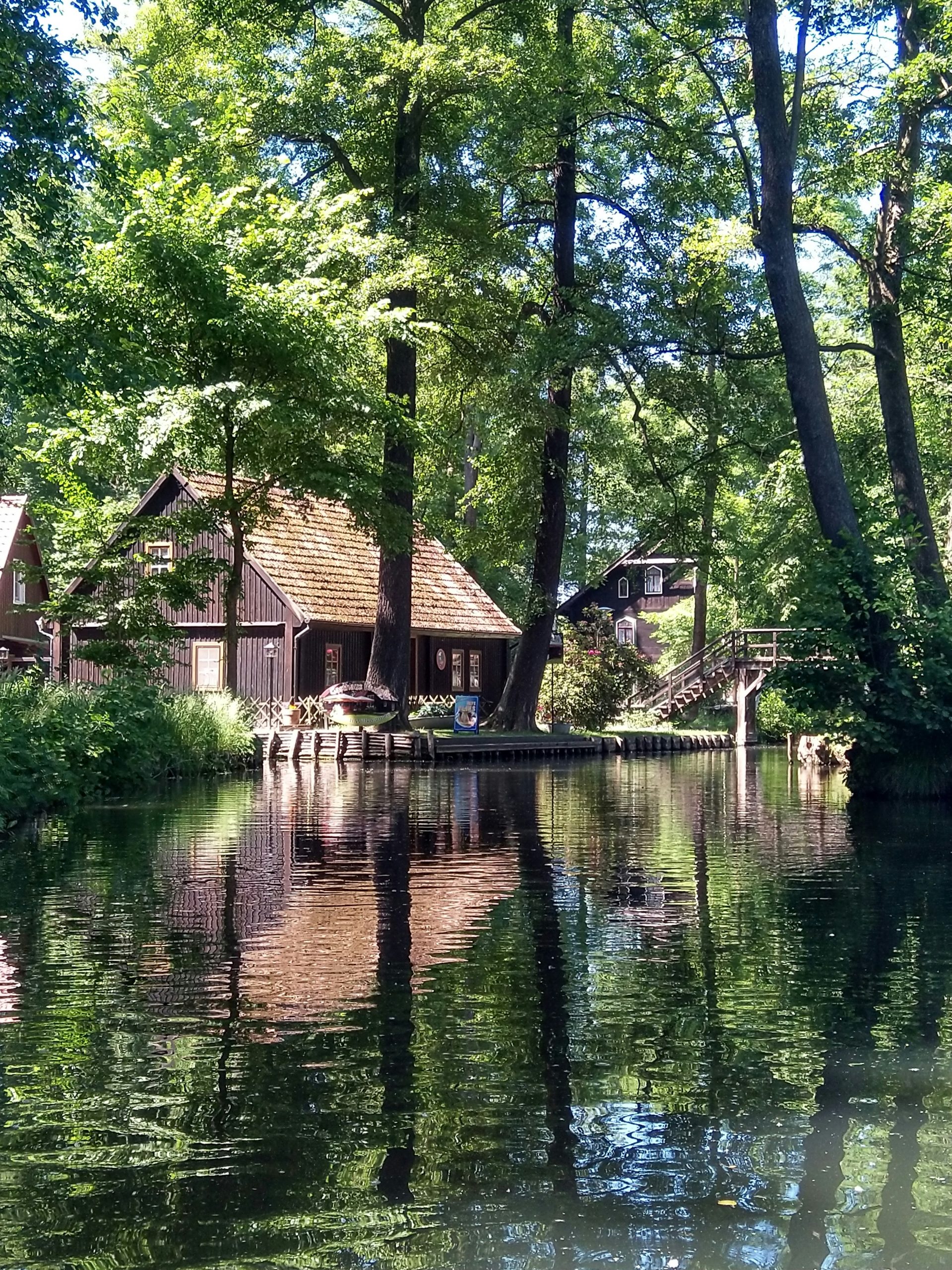 brown wooden house on river during day time, day trips from berlin