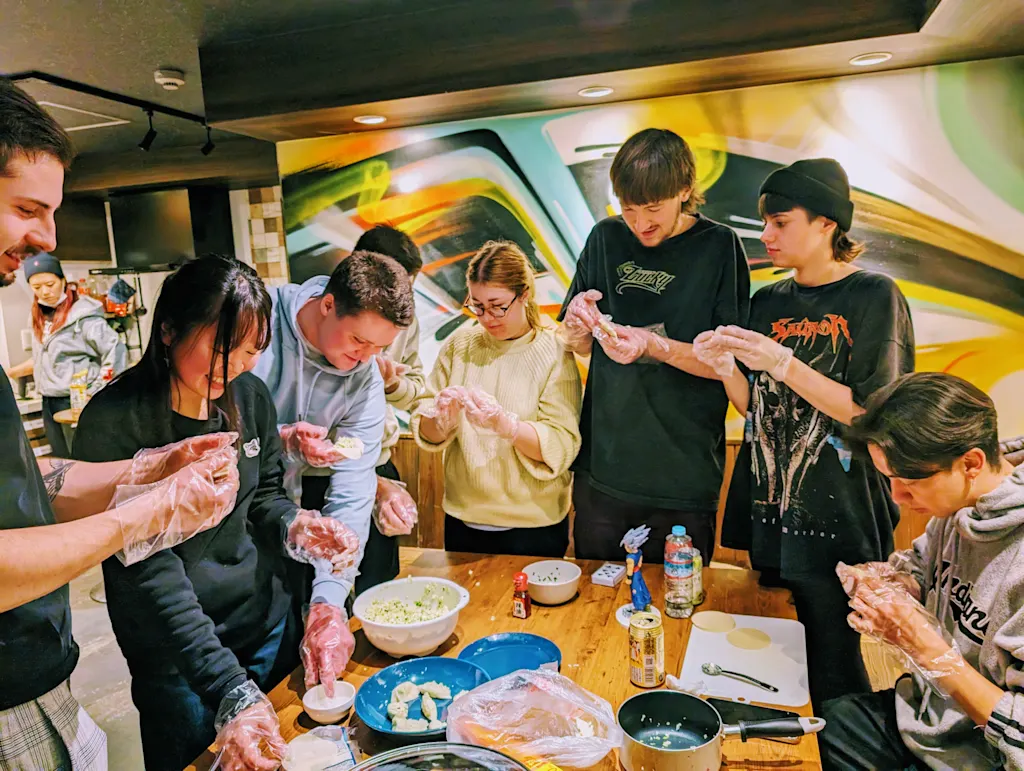 people doing a cooking class in a hostel in osaka