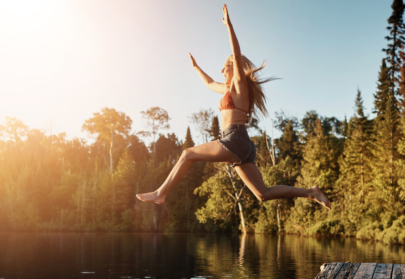 Solo Travel Adventure Woman Jumping to Water