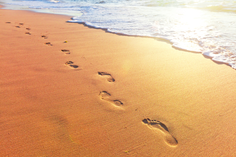 Individual Footsteps at Beach - Solo Travel Benefits
