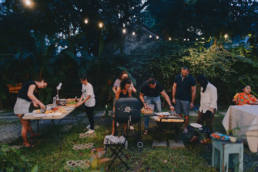 people doing a barbeque outside a hostel