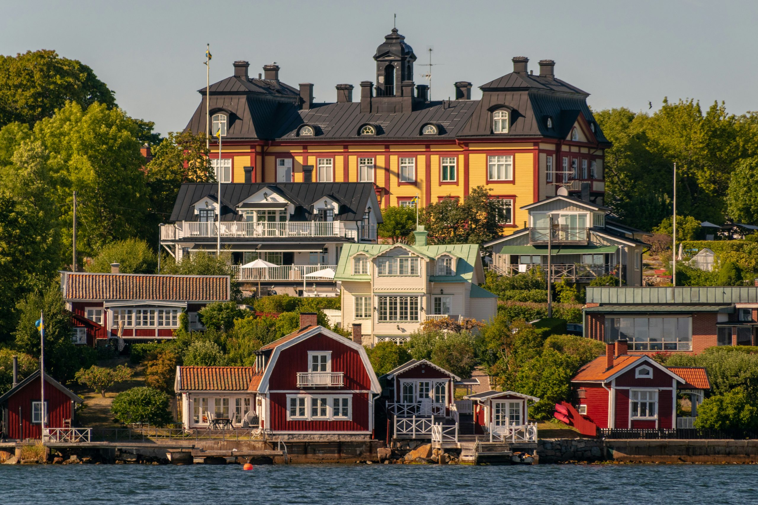 a group of houses next to a body of water