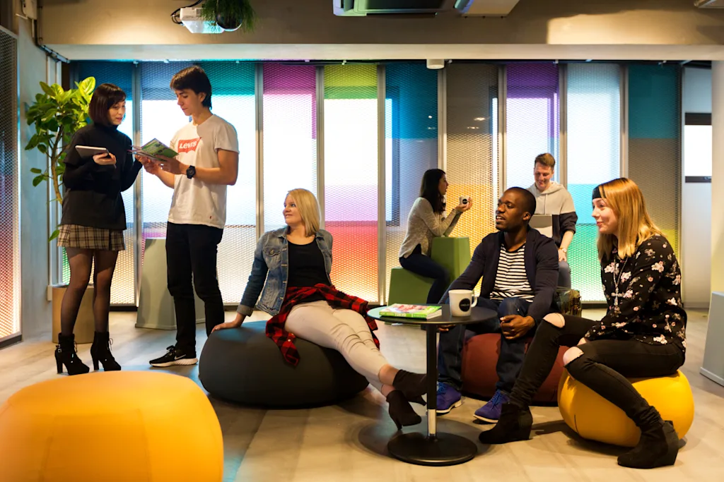 people gathered in a communal area of a hostel