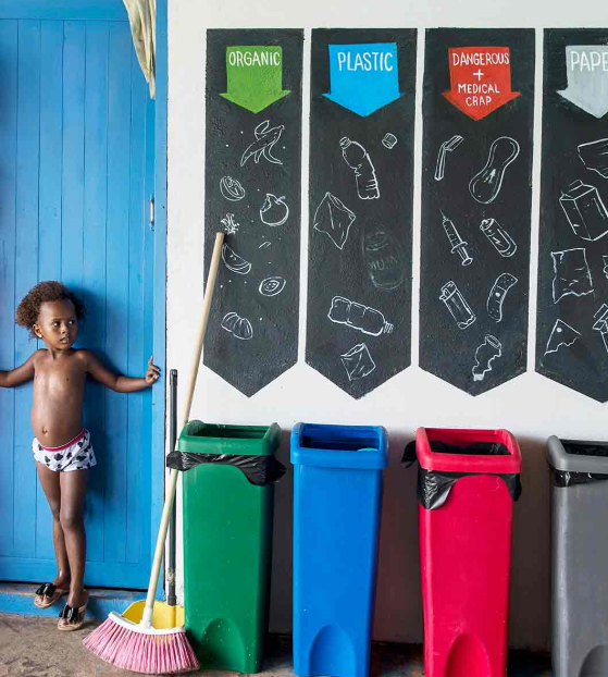 Children next to Recycle Bins at Hostel Casa en el Agua
