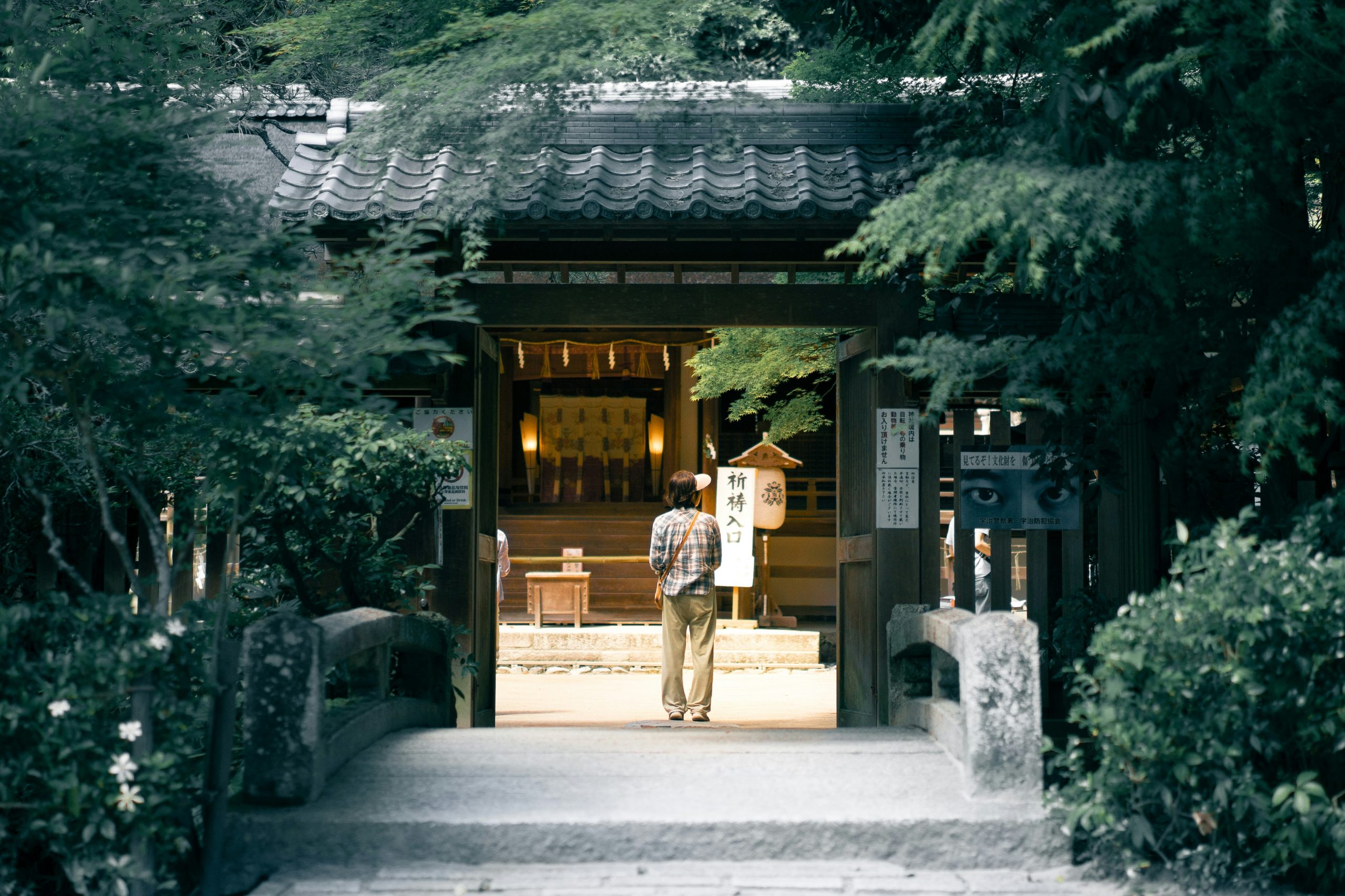 man walking towards brown house in uji, japan. day trips from kyoto