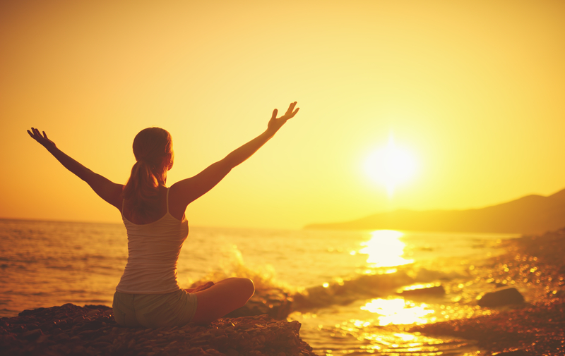 Solo Travel Woman doing Yoga at Sunset on Beach - Benefits of Solo Travel