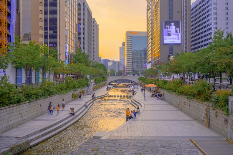 people walking on sidewalk near high rise buildings during daytime in seoul
